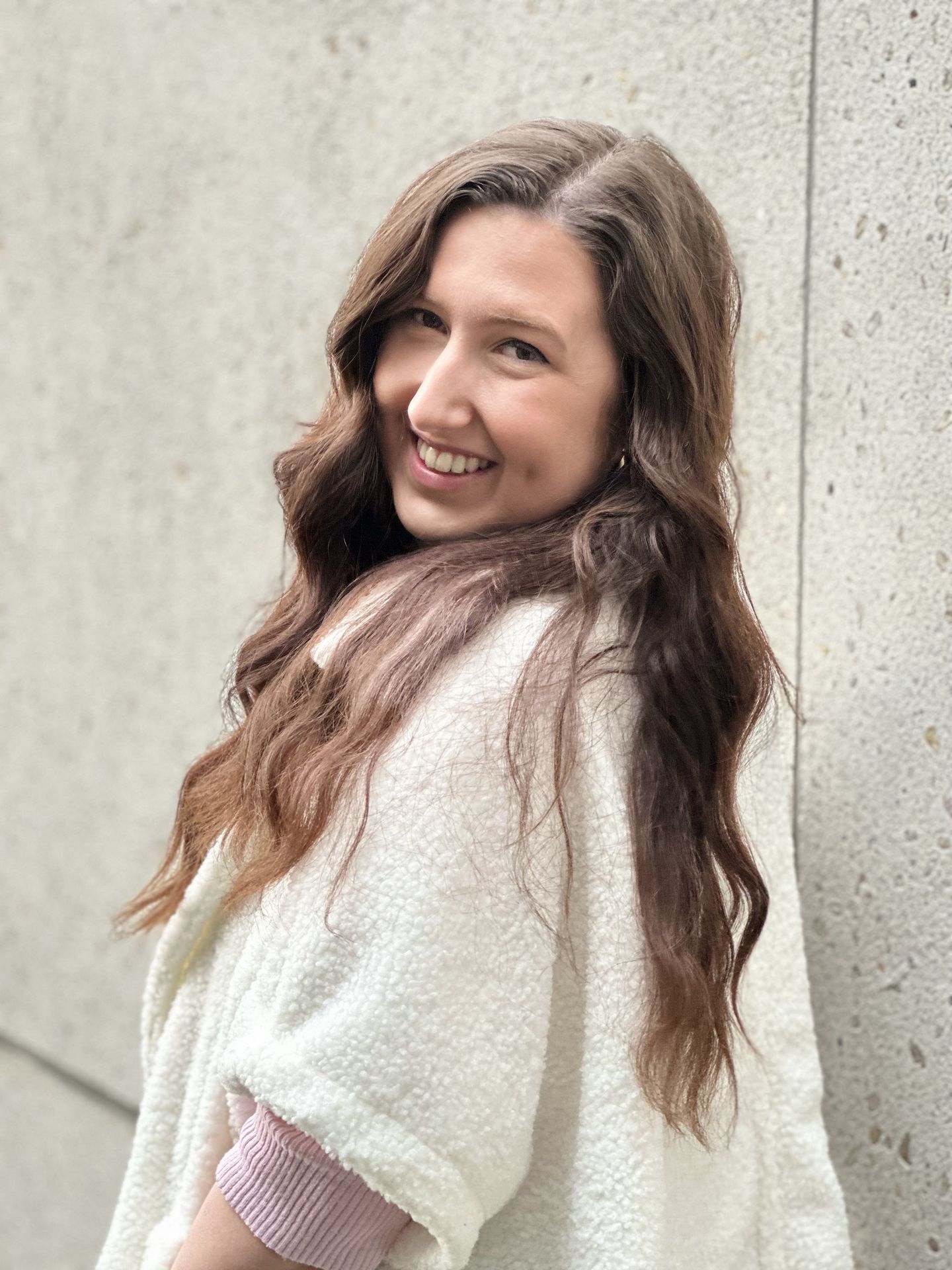 portrait of Laura smiling and looking over shoulder